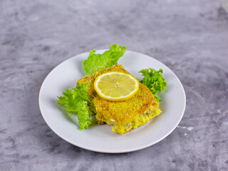 Fillet of fish with lemon on a plate