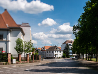 Fototapeta na wymiar Tilt-shift view of the French city of Haguenau in Alsace with empty street during Coronavirus confinement lockdown