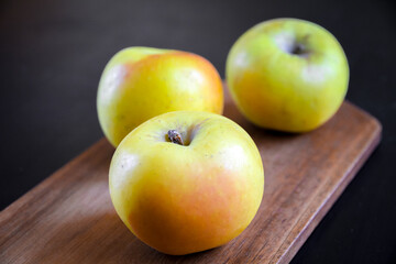 Apples on wooden cutting board