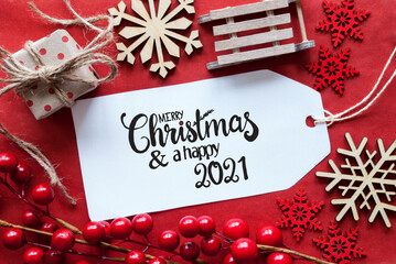 Obraz na płótnie Canvas One Label With English Calligraphy Merry Christmas And A Happy 2021. Bright Red Christmas Deocration Like Sled, Present And Snowlfakes