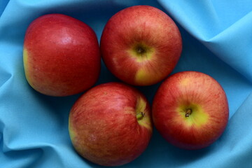 Red Apples on light blue background.