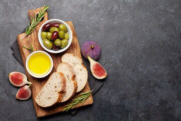 Ripe olives, figs, olive oil and ciabatta bread