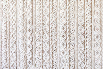 Close-up of hand made macrame texture pattern. ECO friendly modern knitting DIY natural decoration concept  in the interior. Flat lay. Handmade macrame 100% cotton. Female hobby.