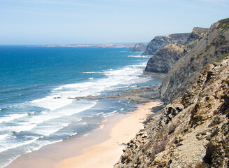 Aerial view of beach, sea and cliff. Sunny day at Cordoama beach, Algarve, Portugal.