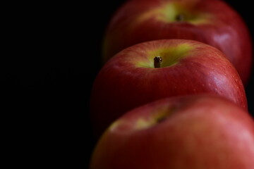 Red Apples on black background.