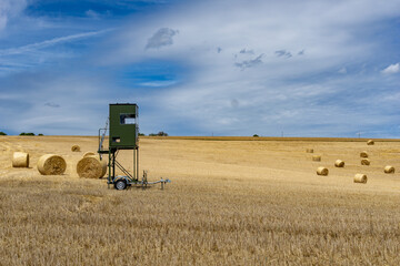 high seat for hunting trailer parked i na golden wheat field