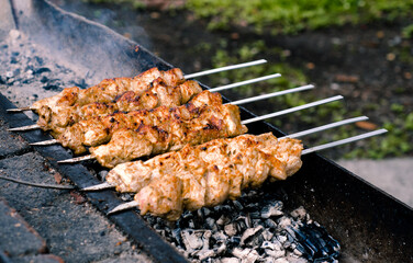 Shish kebab on skewers roasting on the grill. BBQ. Roasted meat.