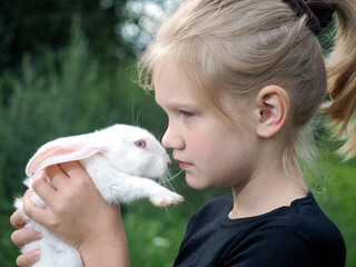 A girl and a rabbit in the village