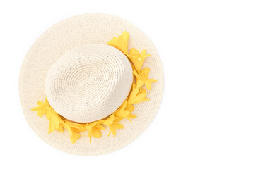 Straw hat with with yellow lily flowers on isolated white background. Stylish retro design template. Yellow background. Summer fashion concept. Copy space. Flat lay style.