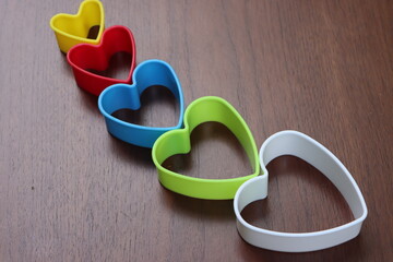Heart shaped cookie cutters on wooden table, love concept © Pravruti