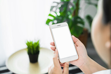Woman hand holding smartphone and touching blank screen. Mockup of advertisement.