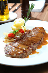 A Plate Of Steak With Mixed Vegetables