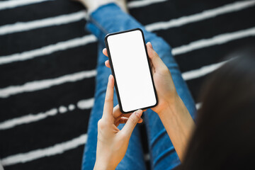 Woman hand holding smartphone and touching blank screen. Mockup of advertisement.