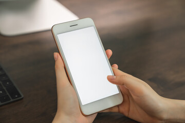 Woman hand holding smartphone and touching blank screen. Mockup of advertisement.