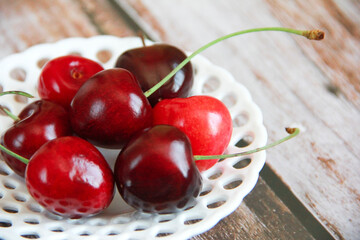 natural red cherry fruits in a decorative plate