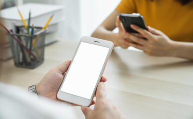 Woman hand holding smartphone and touching blank screen. Mockup of advertisement.