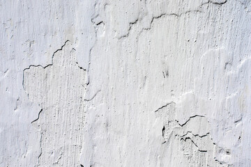 Old white painted wall with cracks as a background. Abstract background.