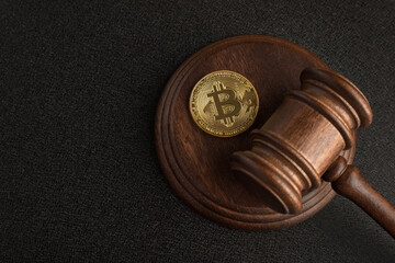 Judge gavel and bitcoin. Cryptocurrency legislation. Bitcoin ban. Violation of law.