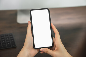 Woman hand holding smartphone and touching blank screen. Mockup of advertisement.