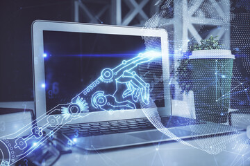 Computer on desktop in office with technology theme hologram. Double exposure. Tech concept.