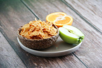 dry Breakfast muesli on a plate and fruit Apple and orange