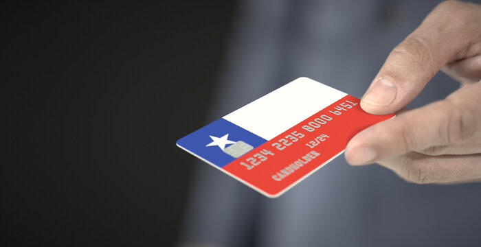 Man gives plastic bank card with printed flag of Chile. Fictional numbers