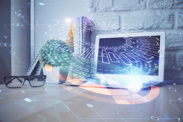 Double exposure of desktop computer and technology theme hologram. Concept of software development.