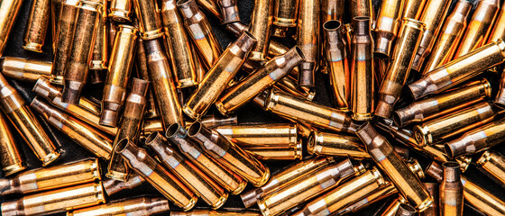 Empty cartridge cases for a carbine or rifle. Background of shiny brass cartridges for cartridges...