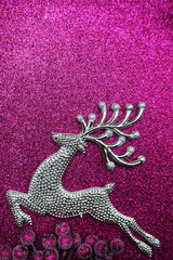 Reindeer and white berry Christmas decoration on pink glitter background