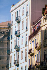 Fototapeta na wymiar View of classic facade of ancient historical buildings in the downtown area of Lisbon, the hilly coastal capital city of Portugal and one of the oldest cities in Europe 