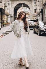 Naklejka premium Young girl poses in a middle of a street. Soft selective focus. Fashion. Streetstyle.