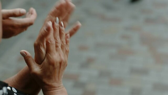 old woman claps her hands