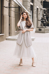 Young girl poses in a middle of a street. Soft selective focus. Fashion. Streetstyle.