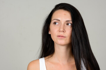 Portrait of beautiful woman against white background