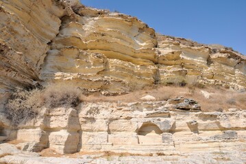 Edge of Kourion plateau with chamber tombs consisting of cist burials cut into the quarried rock shelf of the Neolithic period Kourion Ancient city on the southwestern coast of Cyprus