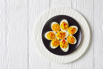 American deviled eggs on a plate, copy space