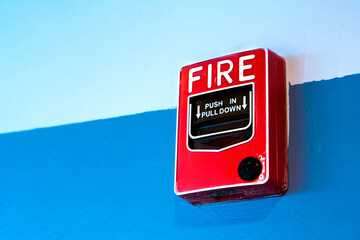 Red button handbrake fire alarm on the wall.