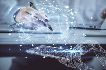 Social network theme hologram over hands taking notes background. Concept of global international people connect. Double exposure