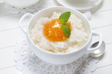 Rice porridge with orange marmalade and lemon balm leaves