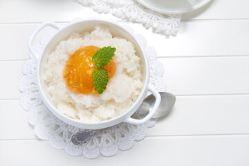 Rice porridge with orange marmalade and lemon balm leaves