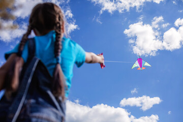 Happy childhood and summertime. Kid having fun and playing with a kite, outdoor