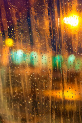 The view from the plane window of the night airport during heavy rain. Selective focus. Blurred image