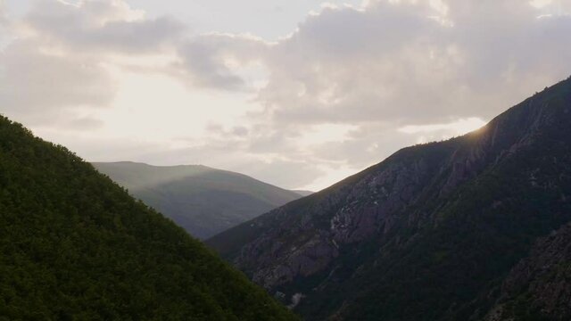 Timelapse of a mountainous landscape with the sun coming in through rapidly moving clouds. Asturias.