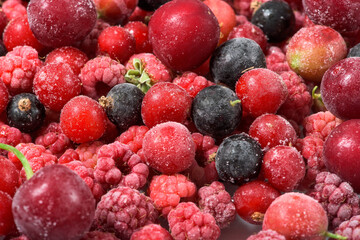 frozen fruit cherry, raspberry, blackcurrant in bags, close-up view from above