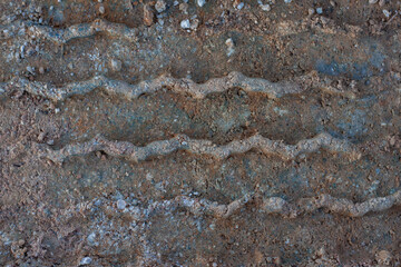 Background and texture of ground where the tire marks drive through.