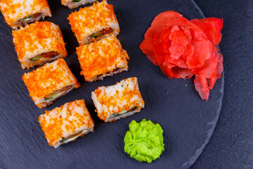 Sushi rolls Philadelphia on a black slate. Top view