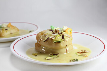 Rajbhog is atraditional Bengali sweet dish made with paneer or chena and served with rabdi and dry fruits.