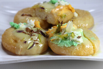 Rajbhog is atraditional Bengali sweet dish made with paneer or chena and served with rabdi and dry fruits.