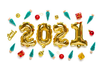 Gold foil balloons numeral 2021, colorful toys, christmas tree, box, balls, bell isolated on white wooden background Flat lay composition Top view Happy New year concept Holiday card