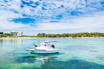 Naklejka na ściany i meble Beautiful emerald lagoon and long beach on Adriatic sea on the island of Pag in Croatia. Boat on surface. Touristic paradise.